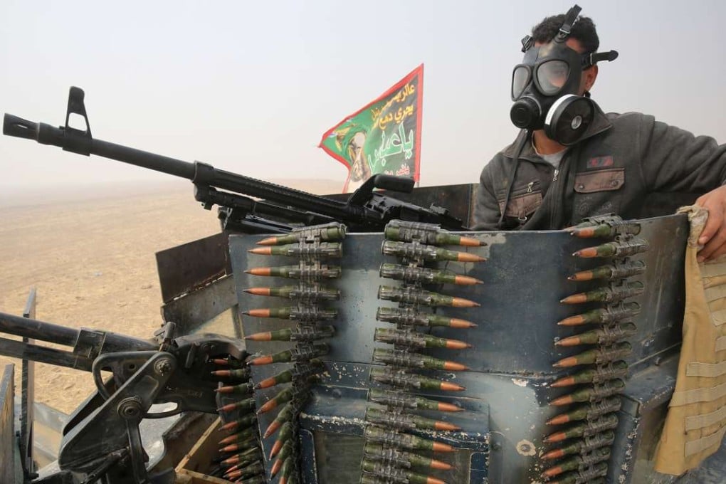 A member of the Iraqi forces in al-Shura, south of Mosul, prepares for an operation to retake the city from Islamic State. Experts say Asian militants fleeing Iraq could return home to pursue jihad. Photo: AFP