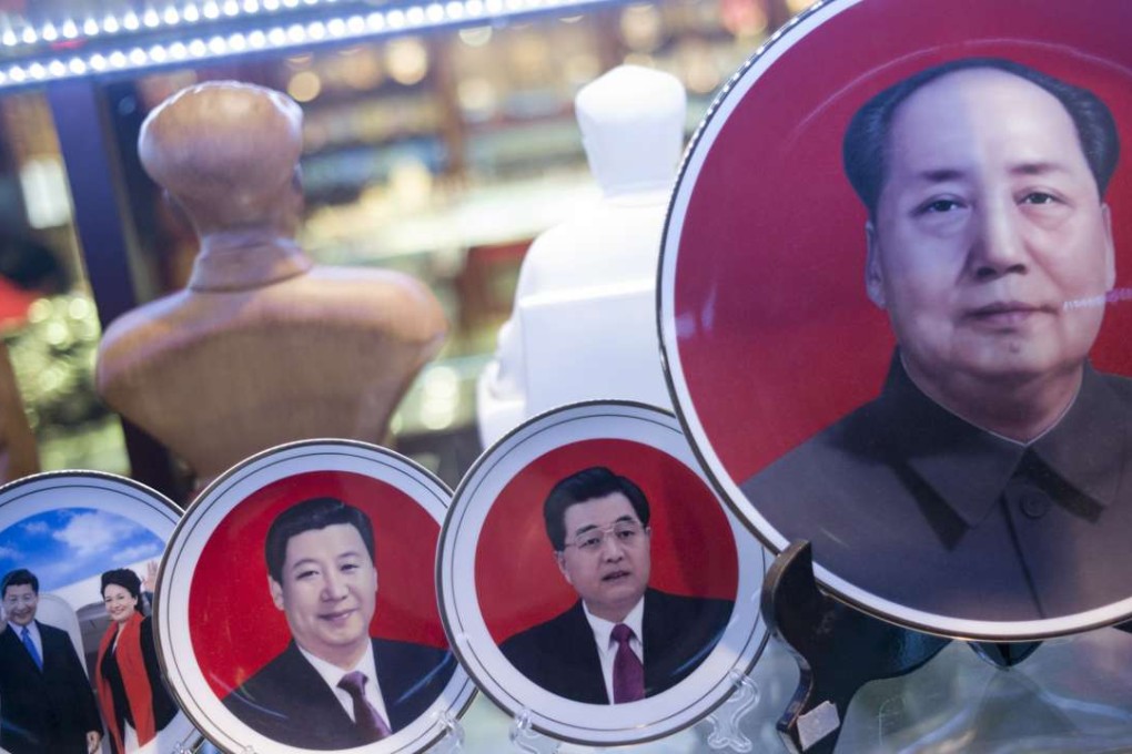 Portraits of Chinese leaders, including Xi Jinping, left, and Mao Zedong, right, on display in a shop in Tiananmen Square at the same time as the plenum. Photo: AFP