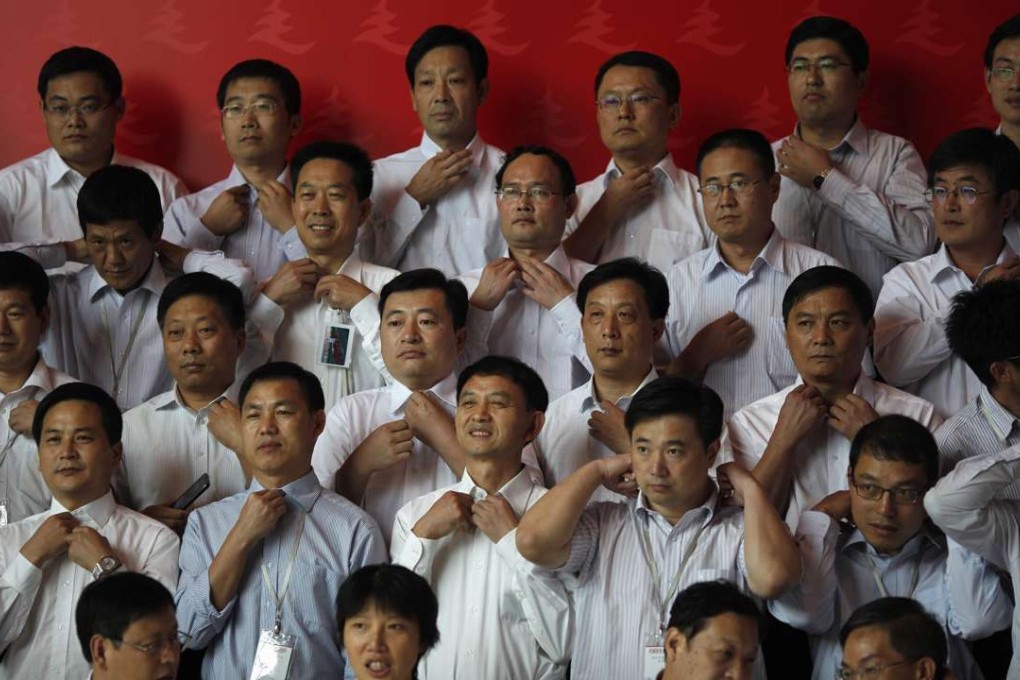 Graduating trainees prepare to pose for a group photo at the Communist Party’s China Executive Leadership Academy of Pudong in Shanghai in 2012. In order to realign cadres’ behaviour with China’s new growth strategy, carrots as much as sticks are needed. Photo: Reuters