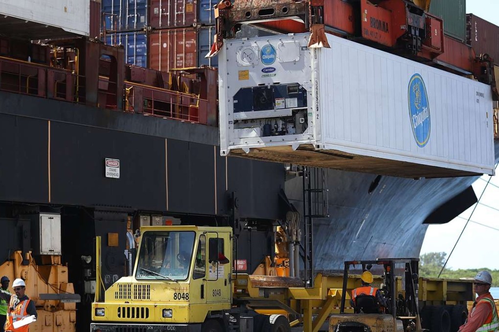 Shipping containers are unloaded from a cargo ship at Port Everglades o in Fort Lauderdale, Florida. US economic growth accelerated to a 2.9 per cent annual rate in the third quarter. Photo: AFP