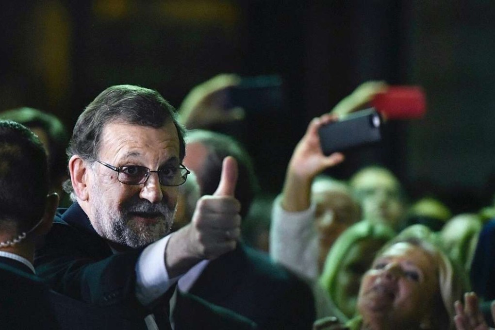Mariano Rajoy gives a thumb up after being elected prime minister. Photo: EPA