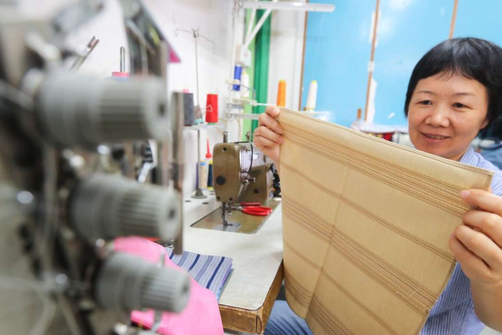 Seamstress Huang Fengteng displayes her handiwork . Photo: Felix Wong