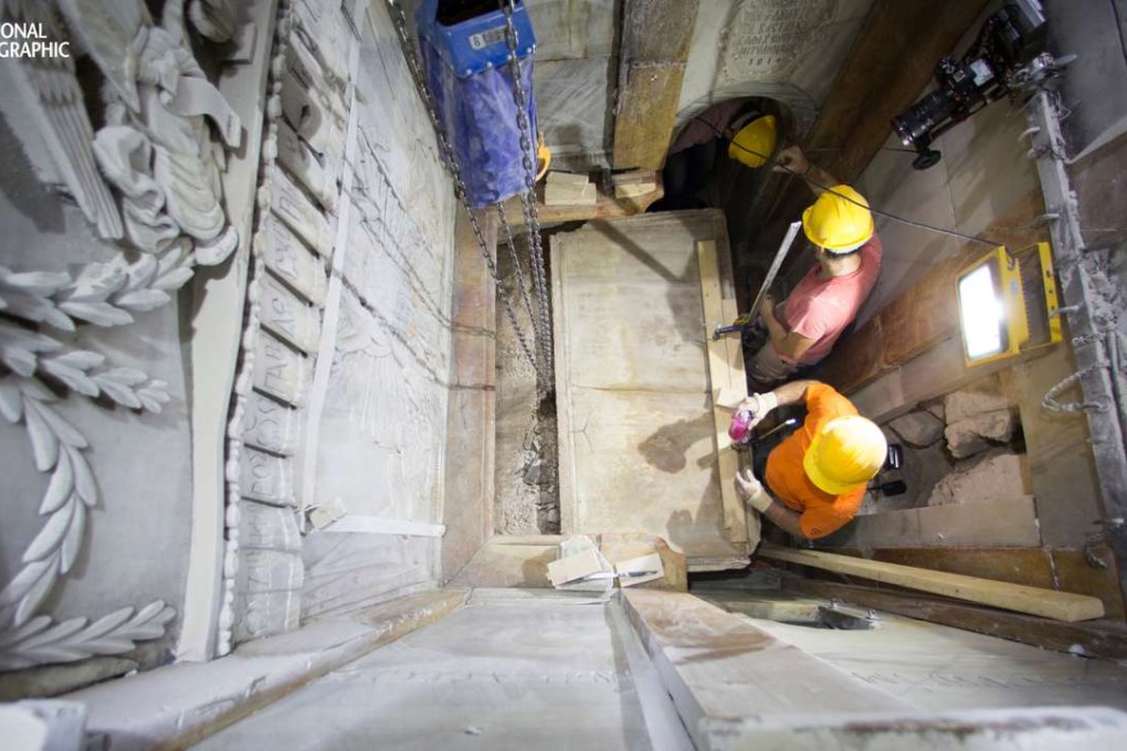 The moment workers remove the top marble layer of the tomb said to be of Jesus Christ, in the Church of Holy Sepulcher in Jerusalem. Photo: National Geographic/AP)