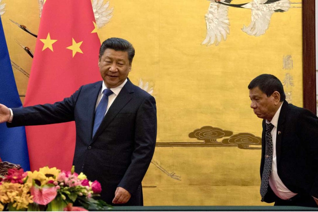 President Xi Jinping leads the way for his Philippine counterpart, Rodrigo Duterte, to a signing ceremony in Beijing on October 20. Photo: AP