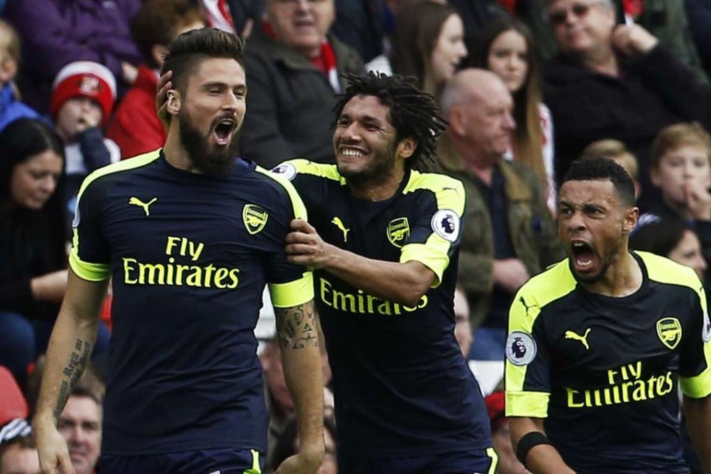 Arsenal's Olivier Giroud celebrates with Francis Coquelin and Mohamed Elneny after scoring their second goal against Sunderland. Photo: Reuters