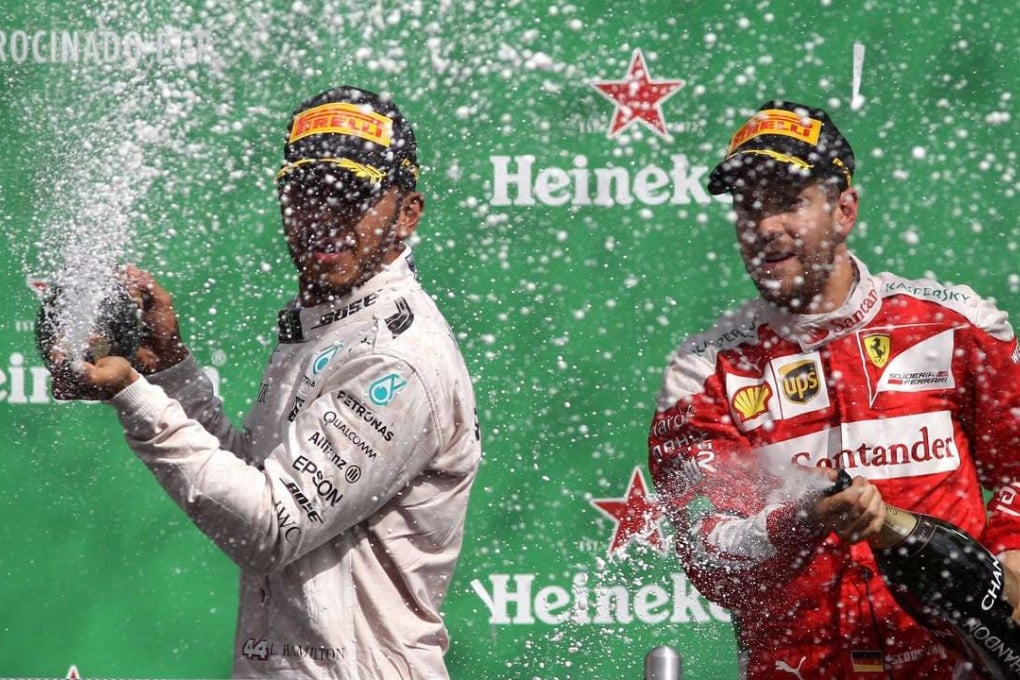 Winner Lewis Hamilton and third placed Sebastian Vettel celebrate at the end of the Mexican Grand Prix. Photo: EPA