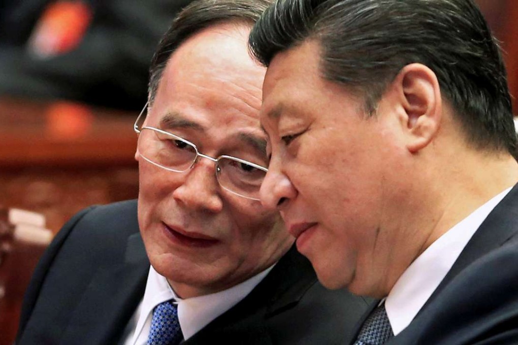 President Xi Jinping (right) speaks to Wang Qishan, the head of the Communist Party’s anti-corruption watchdog, in Beijing last year. Photo: Reuters