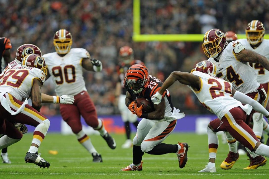 Cincinnati Bengals Giovani Bernard (C) runs at the Washington Redskins defence during their NFL match at Wembley Stadium in London on Sunday. The match finished tied. Photo: EPA