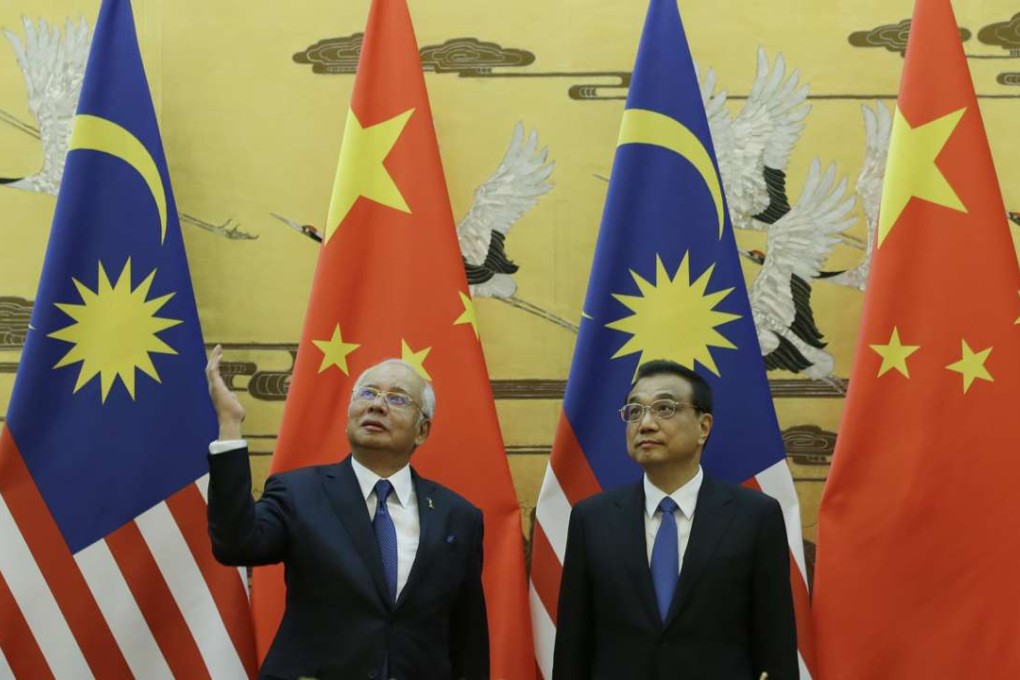 Malaysian Prime Minister Najib Razak and Premier Li Keqiang attend a signing ceremony at the Great Hall of the People in Beijing on Tuesday. Photo: AFP