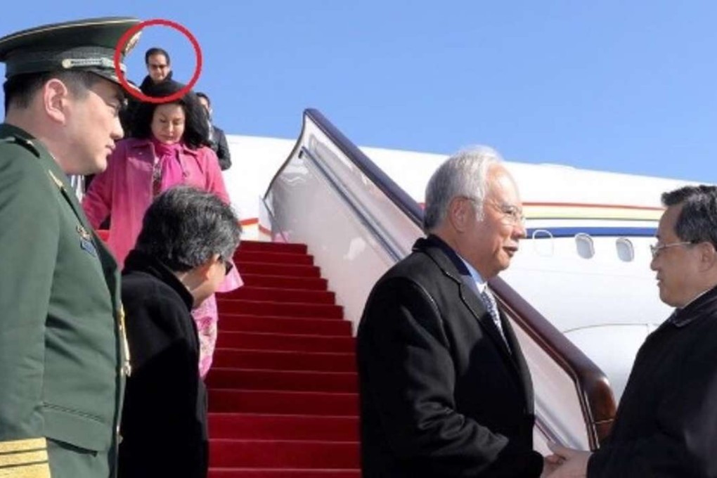 Najib Razak’s stepson Riza Aziz (circled red) exits the delegation’s official plane after it arrived in Beijing on Monday. Pictured below him are his mother Rosmah Mansor and Najib. Photo: Twitter