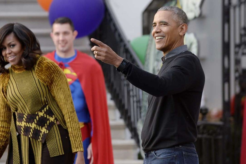 US President Barack Obama (R) and first lady Michelle Obama (L) attend a Halloween event at the South Lawn of the White House. Photo: EPA
