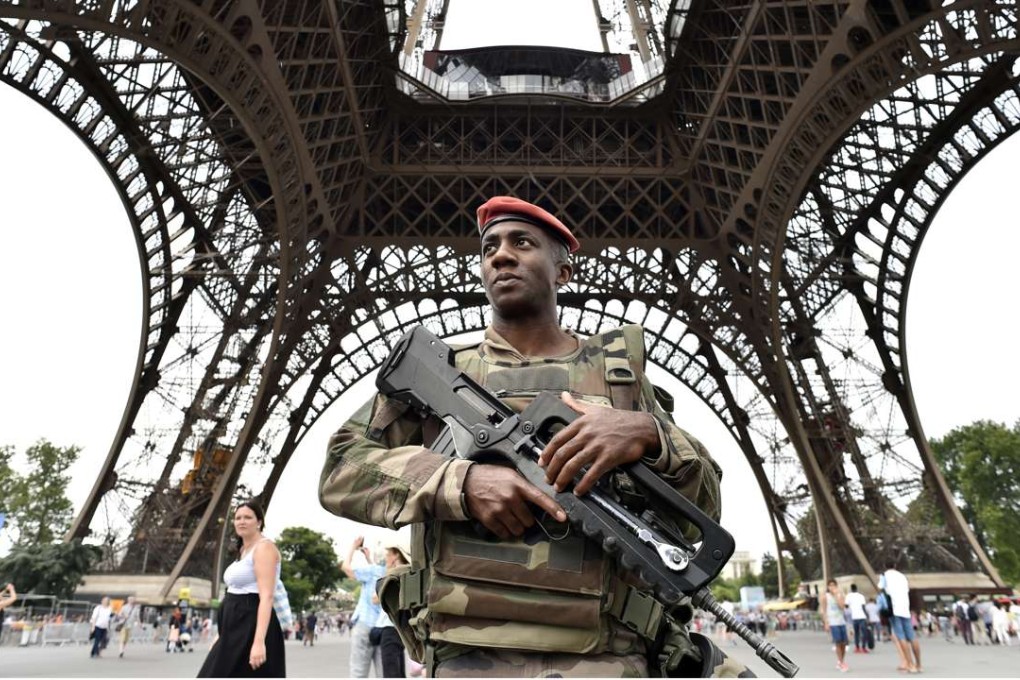 An armed French soldier patrols under the Eiffel tower in Paris. Photo: AFP