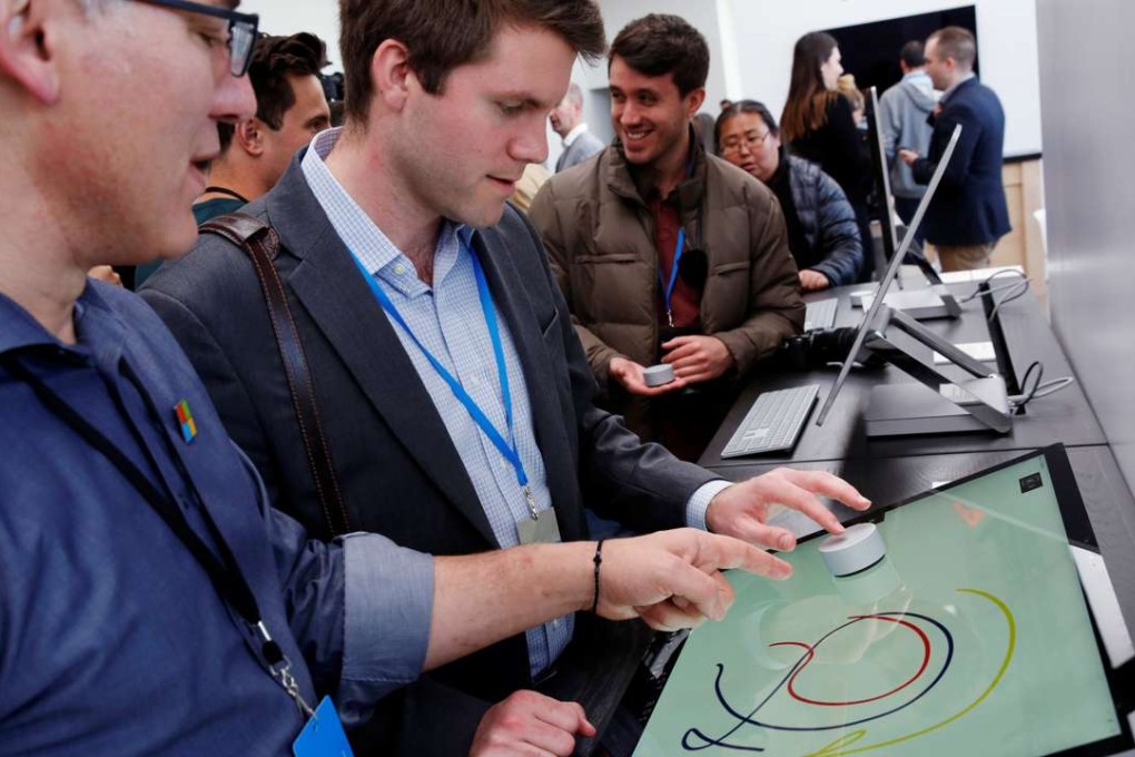 Journalists use a dial as they inspect examples of the Microsoft Surface Studio computer in New York. Photo: Reuters