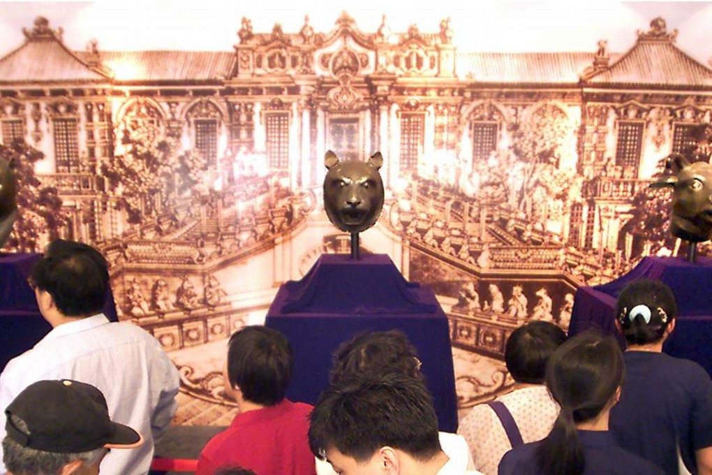 Three bronze heads, of a monkey, a tiger and an ox, are display at a private museum in Beijing in May 2000 after they were bought by a mainland company at an auction in Hong Kong. Considered national treasures from the old Summer Palace, the looted relics sparked an outcry from Chinese media, scholars and politicians when they were put up for sale. Photo: AFP