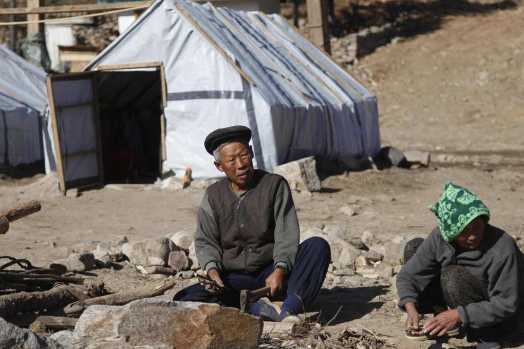 A picture supplied by the Finnish Red Cross last month of a couple living in a temporary shelter after the flooding in North Korea. Photo: AFP