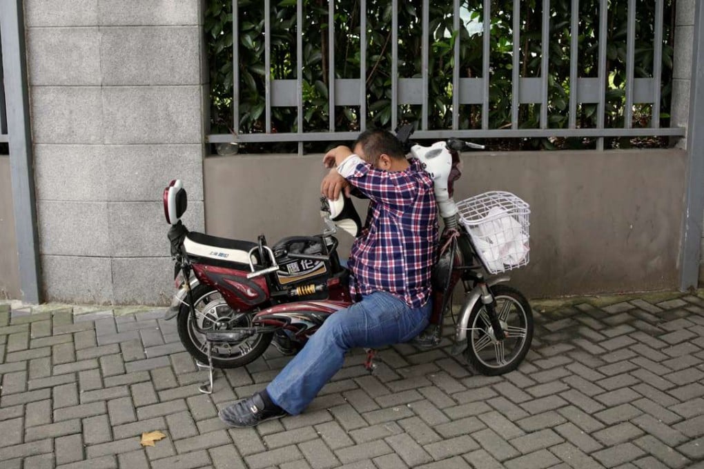 A man takes a nap on his electric bike in Shanghai. China is said to have a traditional culture that values care and giving. But such strong philanthropic traditions have effectively been dismantled under Mao’s ruling philosophy of “class struggle”. Photo: Reuters