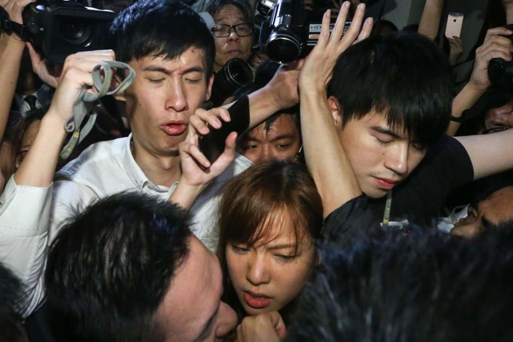 Sixtus Baggio Leung Chung-hang and Yau Wai-ching outside the Legco chamber, attempting to force their way in amid the media scrum, a ring of supporters and security. Photo: Sam Tsang