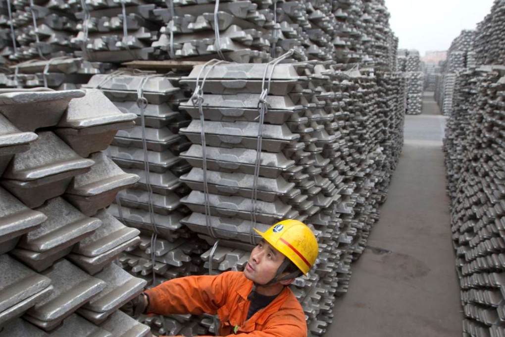 An employee checks aluminium ingots for export at the Qingdao Port, Shandong province, China. Photo: Reuters