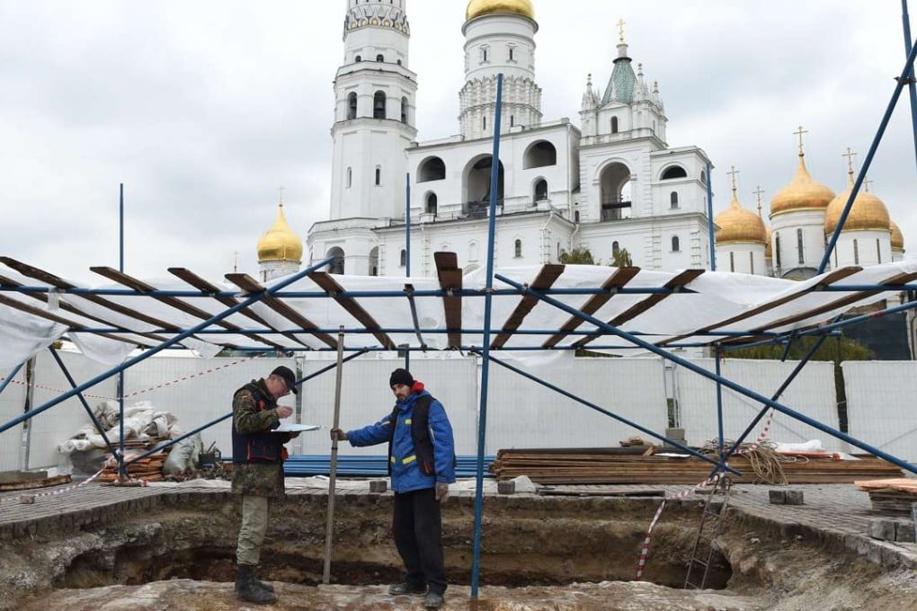 Archaeologists dig during excavation work at the site of a dismantled 1930s-era Kremlin administration building, known as the 14th wing, in central Moscow. Photo: AFP