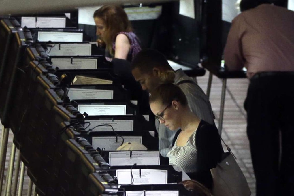 People cast early votes at a polling station in Miami on Tuesday. Photo: AP