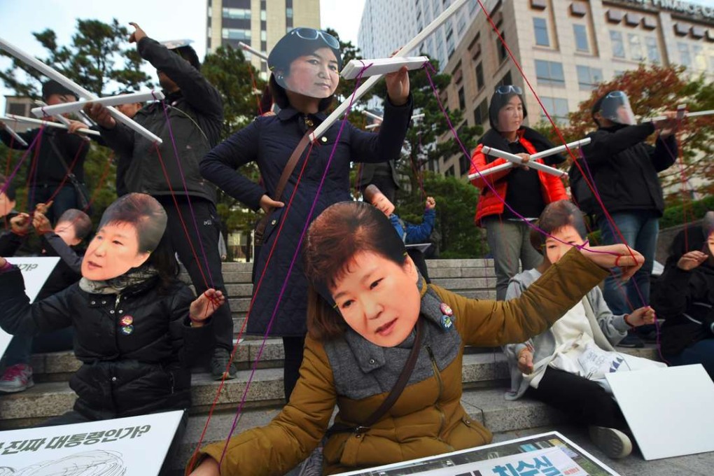 Protesters wearing masks of South Korean President Park Geun-Hye, front, and her confidante Choi Soon-Sil protest in central Seoul. Photo: AFP