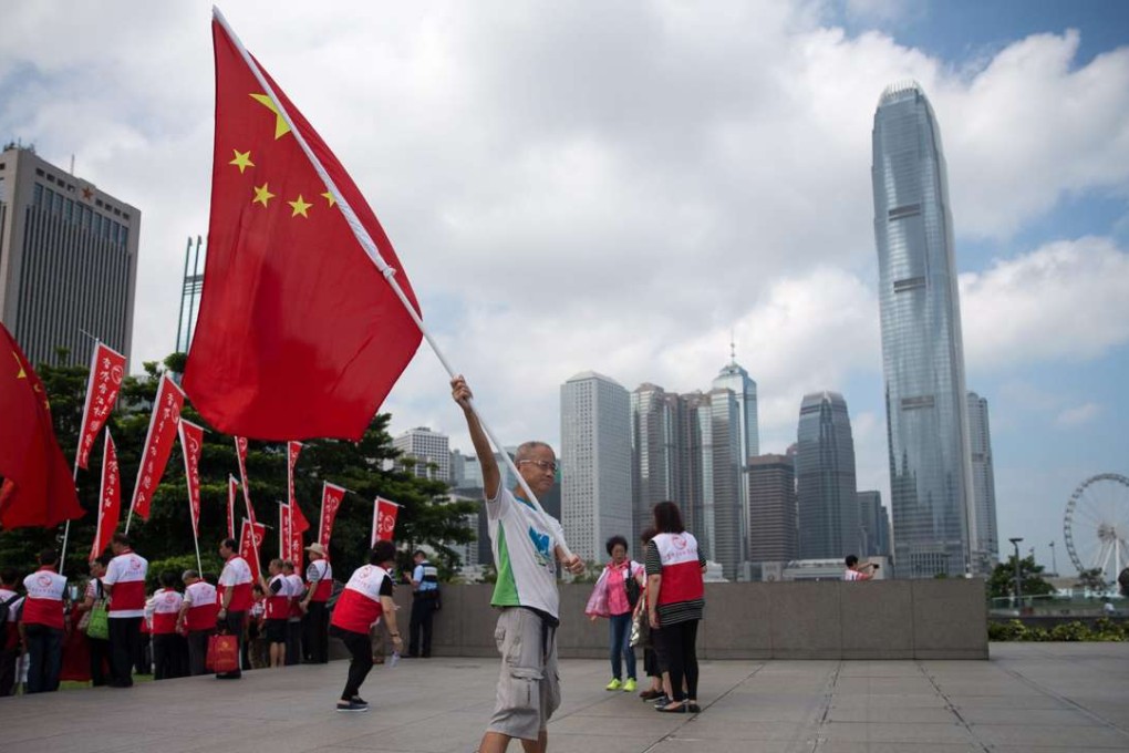 Protesters wave the national flag and banners at a rally outside the Legislative Council chamber last month, calling for the disqualification of Youngspiration lawmakers-elect Sixtus Leung and Yau Wai-ching. Photo: EPA