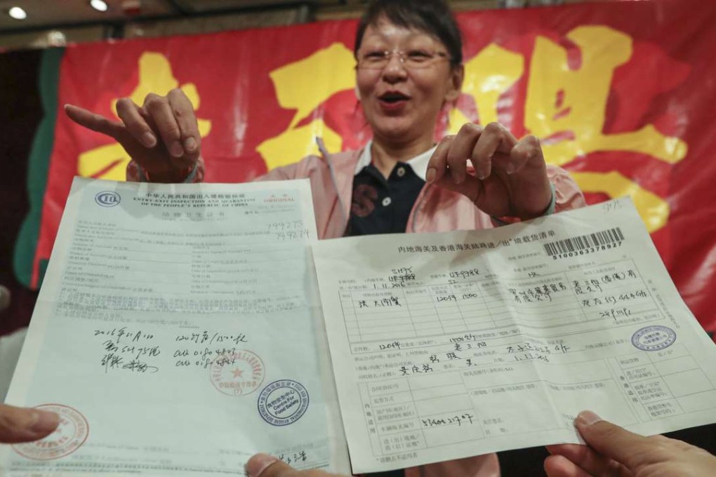 Old San Yang director Sandy Ki displays some documents relating to crab imports. Photo: Dickson Lee