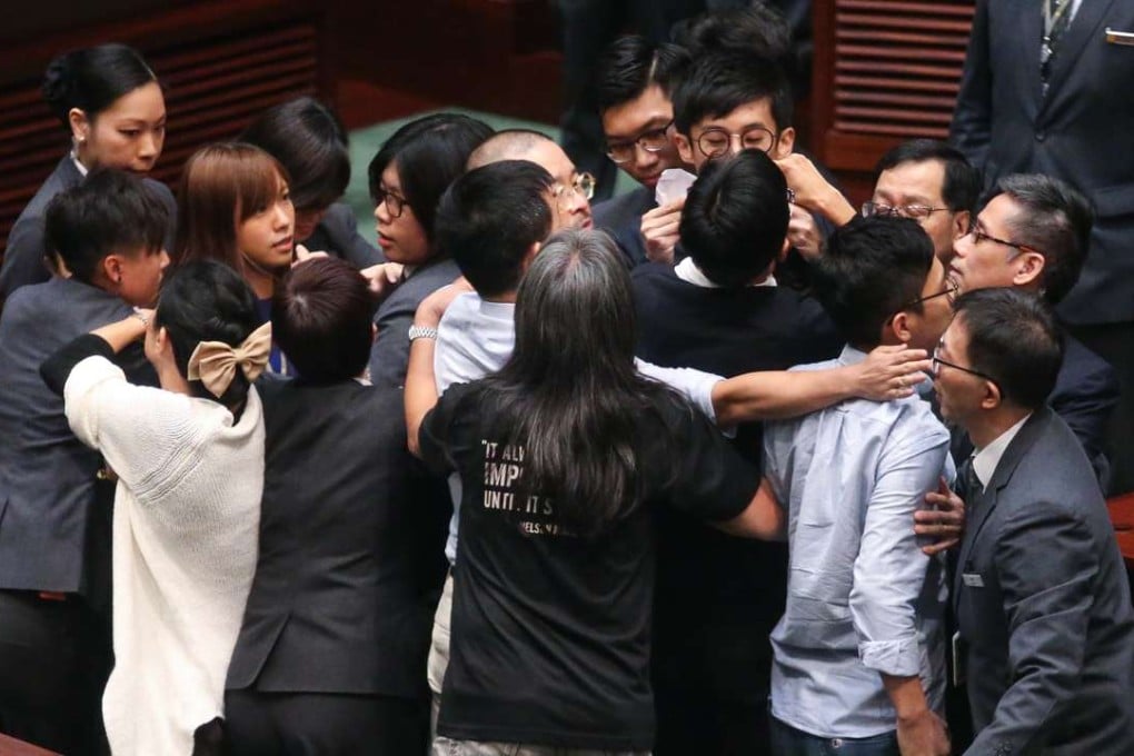 Fellow lawmakers confront security guards while Yau Wai-ching and Baggio Leung Chung-hang tried to take the oath. Photo: K. Y. Cheng