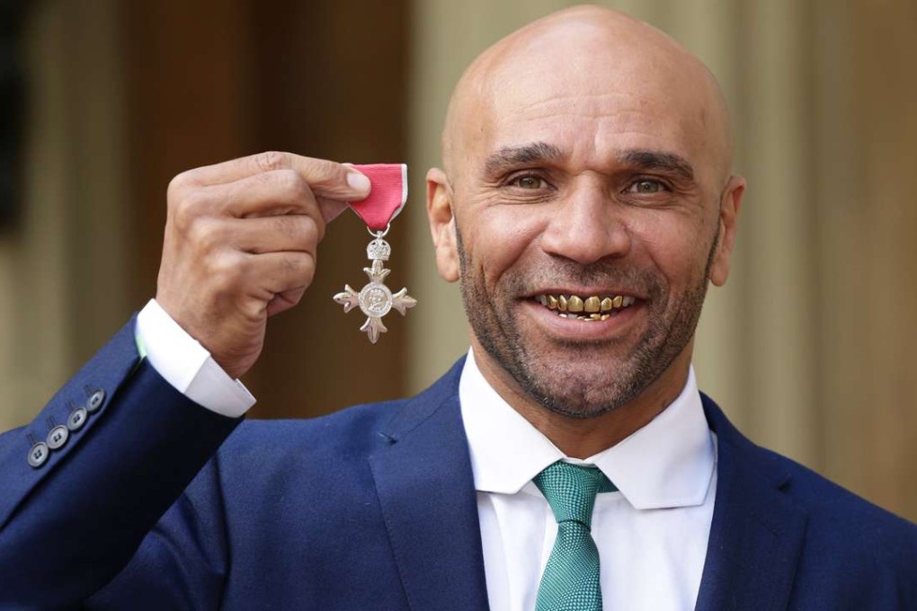 Goldie receives his MBE.