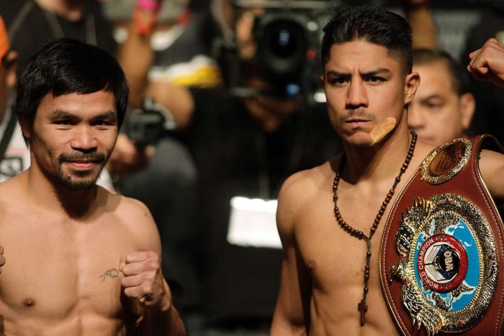 Boxers Manny Pacquiao and Jessie Vargas pose together during their official weigh-in. AFP