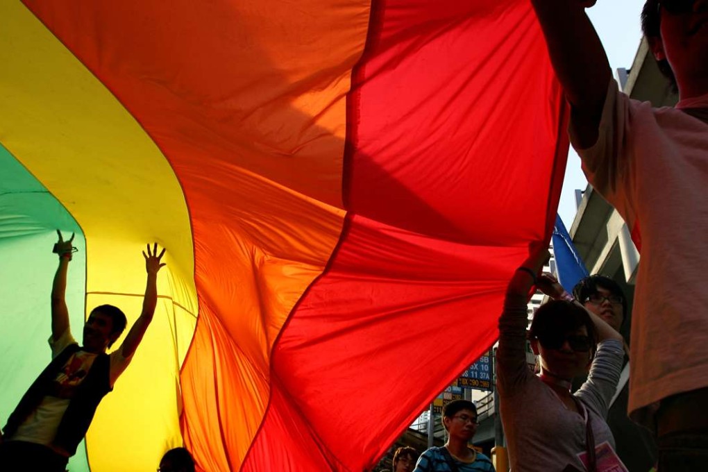 A rainbow flag held aloft at a Hong Kong Pride Parade march. Photo: Jonathan Wong