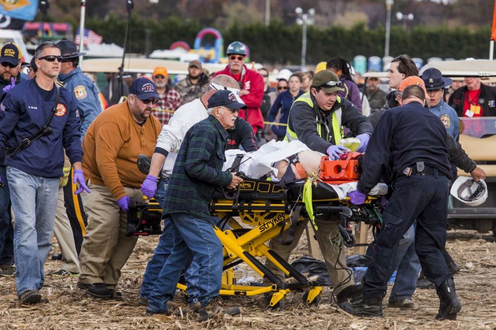 Paramedics transport an injured spectator to an ambulance after a pumpkin-launcher exploded at the World Championship Punkin Chunkin Contest in Bridgeville, Delaware on Sunday. Photo: AP