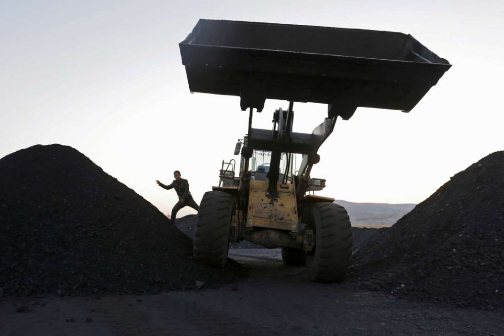 A file picture of workers operating an excavator at a coal depot in Heilongjiang province. Photo: Reuters