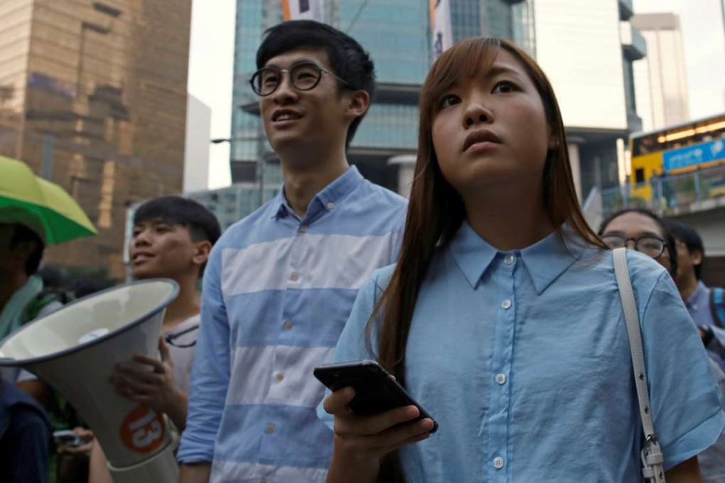 Pro-independence legislator-elects Baggio Leung (C) and Yau Wai-ching (R) took part during a protest against Beijing's interference over local politics and the rule of law, a day before China's parliament was expected to announce their interpretation of the Basic Law in light of their oath-taking controversy. Photo: Reuters