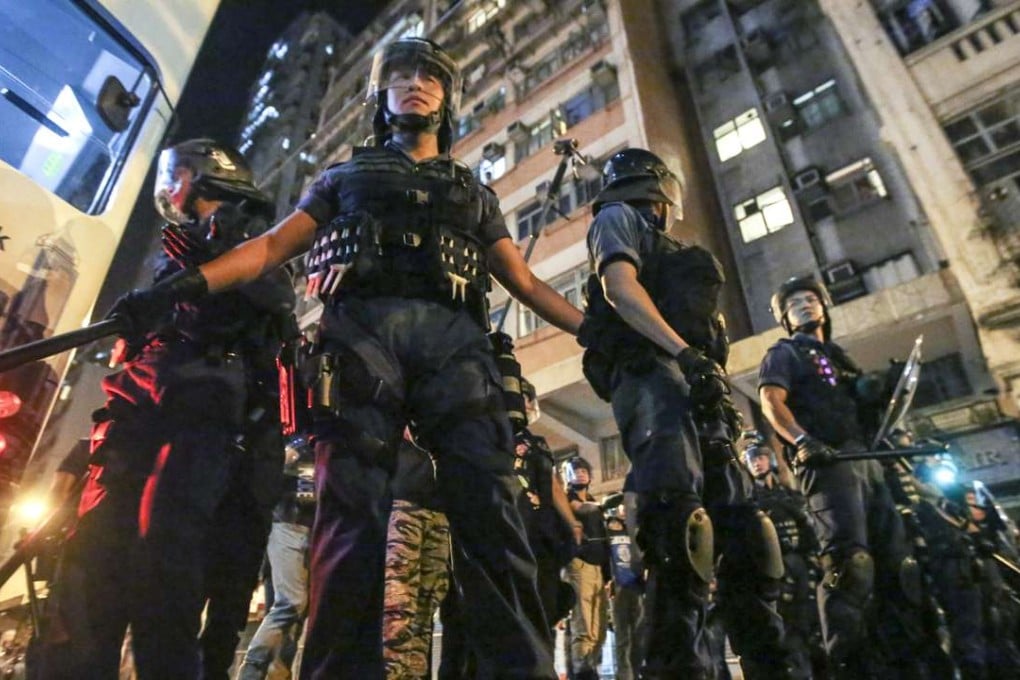 Police line Des Voeux Road near the central government’s liaison office in Hong Kong early Monday. Photo: Edward Wong