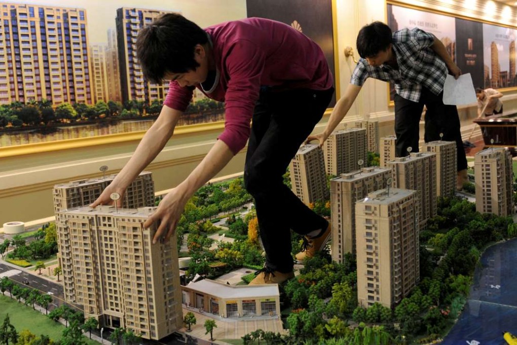 Employees set up model apartments as they prepare for a property exhibition in Hangzhou, Zhejiang province. Photo: Reuters