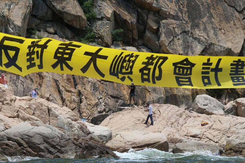 Activists against the creation of an East Lantau Metropolis put up a banner in Kau Yi Chau during a protest in June. Photo: K. Y. Cheng