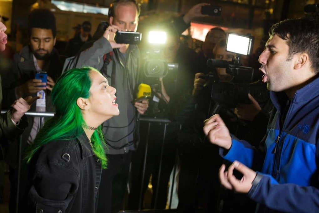 A protester argues with a supporter of Donald Trump outside Trump Tower in New York City after midnight on election day. Riding a wave of popular resentment, Trump stunned America and the world to defeat Hillary Clinton in the race to become the 45th president of the United States. Photo: AFP