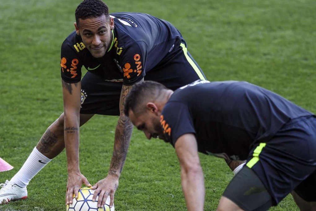 Neymar (L) and Renato Augusto (R) of Brazilian national soccer team takes part in a training session at Mineirao stadium in Belo Horizonte. EPA/ANTONIO LACERDA
