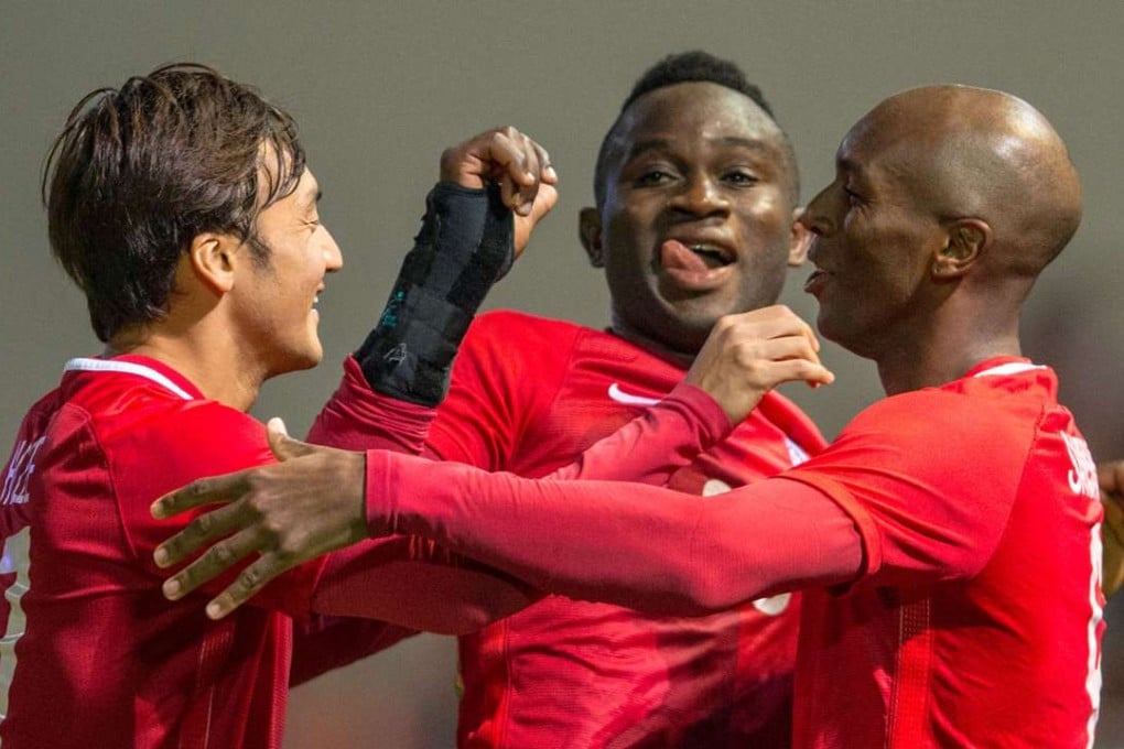 Alex Akande (centre) celebrates a goal with his Hong Kong teammates. Photo: SCMP Pictures