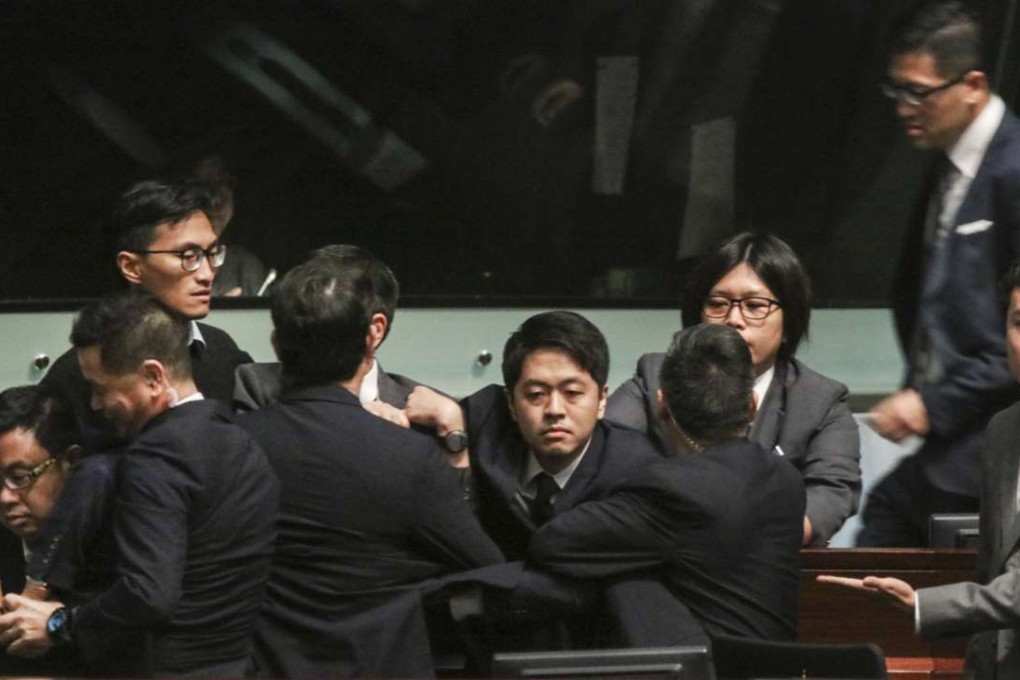 Democratic Party lawmaker Ted Hui Chi-fung (centre) was ordered to leave the Legislative Council meeting on Wednesday. Photo: Felix Wong