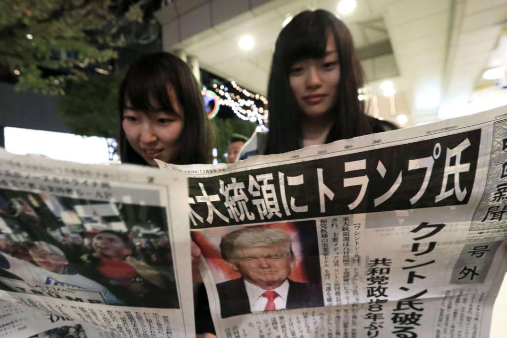Women read about Donald Trump’s victory in the US presidential election, in Nagoya in central Japan on Wednesday. Photo: Kyodo
