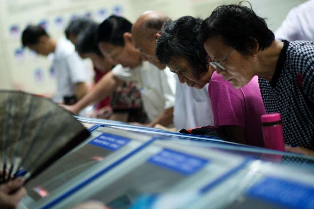 Investors look at stock prices at a securities exchange in Shanghai. Photo: AFP
