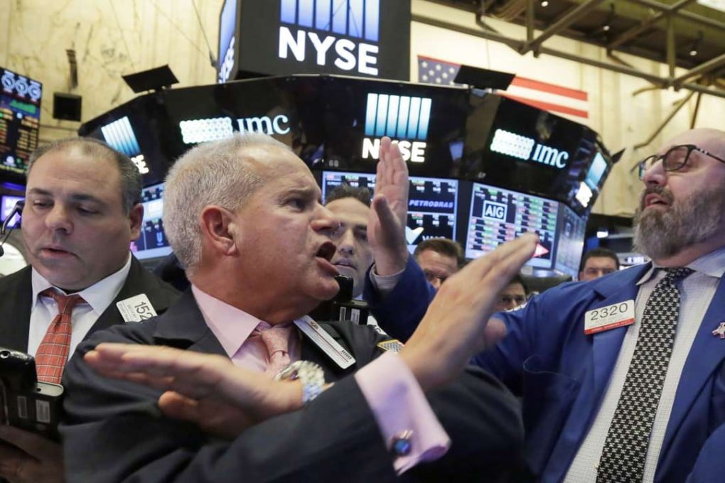 Executive Floor Governor Rudy Mass, centre, and specialist Peter Giacchi, right, call out prices for Weatherford, on the floor of the New York Stock Exchange as stocks moved higher late on Wednesday. Photo: AP