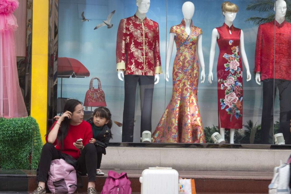 Mannequins display traditional Chinese dresses at a shop in Beijing. Photo: AP