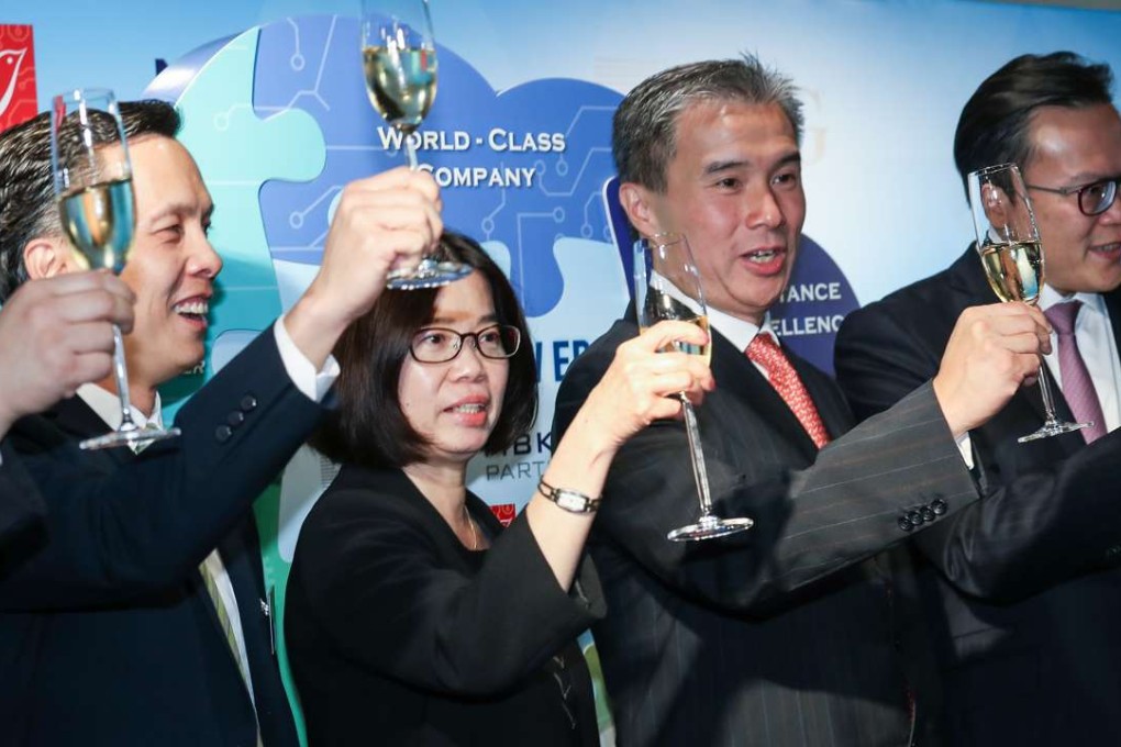 From left to right: Ricky Lau, partner, TPG; Agnes Tan, vice president of Wharf T&T; Vincent Ma, CEO of Wharf T&T; and Kong Teck Chien, partner, MBK Partners, toast the deal during a media briefing in Hong Kong on Thursday. Photo: Nora Tam