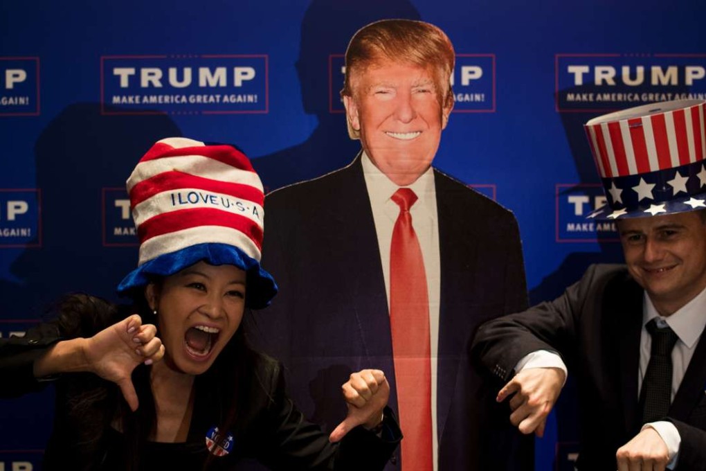 A couple poses next to a cardboard cutout of US presidential candidate Donald Trump during an election event organised by the US consulate in Shanghai on Wednesday. Photo: AFP