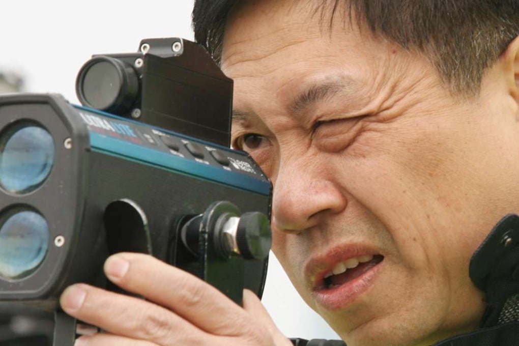 inspector Lam Yam-man tests a laser gun in 2008.