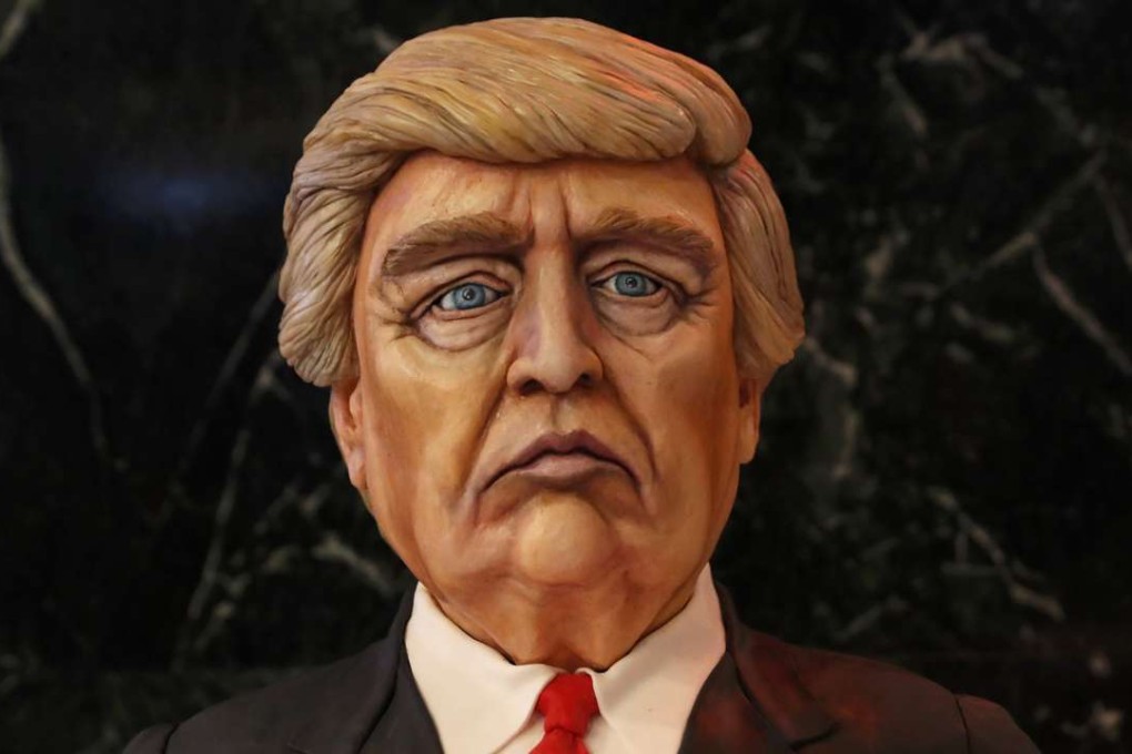 A cake made in the image of Donald Trump on display at his election night rally in Manhattan, New York. Will Trump build the equivalent of the Great Wall of China along the Mexican border? Will he ban Muslims from entering the US? Will he tear up international trade agreements? Photo: Reuters