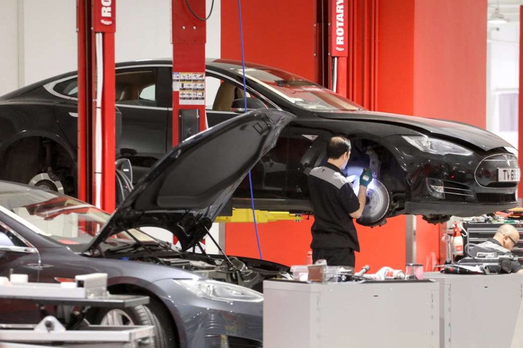 Tesla electric cars are seen being serviced at its Hong Kong facility. The electric vehicle market is becoming a crowded field in China. Photo: Felix Wong